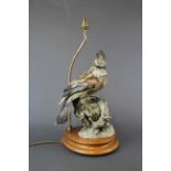 A large resin and wood table lamp base of a Jay, H. 50cm.