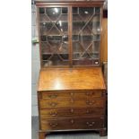 A 20th C mahogany bureau display cabinet with leather interior and multiple drawers, H. 206cm W.