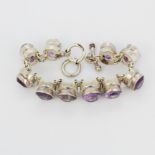 A heavy 925 silver bracelet set with large oval cut amethysts, stone size 1.5 x 1cm, bracelet L.