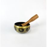 A Tibetan bronze singing bowl, Dia. 10cm.
