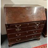 A Georgian mahogany bureau with inlaid decoration of a man between columns to central inside door