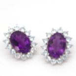 A pair of 925 silver cluster earrings set with oval cut amethysts and blue topaz, L. 2.2cm.