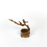 A small Chinese bronze figure of a bird of a branch, H. 7.5cm.