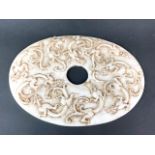 A Chinese carved white jade/hardstone oval disc carved nine dragons, W. 30cm.