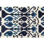 An Indian beige and blue ground wool ikat rug, 225 x 168cm.