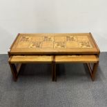 A 1970's teak and tile topped coffee table with two nesting side tables, overall 104 x 48 x 40cm.