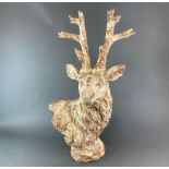 A large painted fibre glass and plaster sculpture of a stag painted to resemble terracotta, H. 78cm.