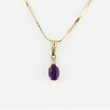 A 14ct yellow gold pendant set with an oval cut amethyst and diamond on a 14ct yellow gold chain, L.