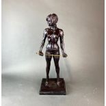 A large bronze figure of Miss Whiplash with a black marble base, H. 56cm.