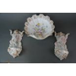 Two continental porcelain wall mounted holy water pockets, H. 29cm, together with a porcelain