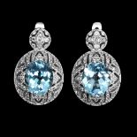 A pair of 925 silver earrings set with oval cut blue topaz and white stones, L. 2.5cm.