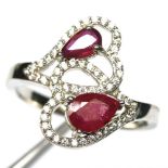A 925 silver ring set with pear cut rubies and white stones, (O).
