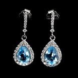 A pair of 925 silver drop earrings set with pear cut blue topaz, and white stones, L. 2.2cm.