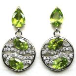 A pair of 925 silver drop earrings set with oval cut peridots and white stones, L. 2.4cm.