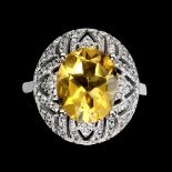 A 925 silver cluster ring set with a large oval cut citrine and white stones, (O.5).