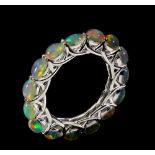 A 925 silver full eternity ring set with cabochon cut opals, (N.5).
