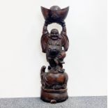 A large Chinese carved hardwood figure of Putai holding cash, H. 70cm.