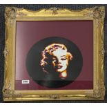 An unusual gilt framed portrait of Marylin Monroe painted on a vinyl record, 53 x 52cm.