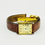 A lady's Cartier gold on silver tank watch, W. 2.2cm.