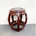 A Chinese carved red hardwood stool, Dia. 42cm. H. 46cm.