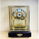 A contemporary four glass rolling ball mantle clock, H. 30 x 27 x 43cm.