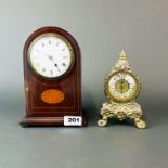 An Edwardian inlaid mahogany mantle clock, H. 21cm. Together with a gilt metal mantle clock.