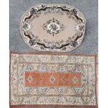 An eastern wool rug, 200 x 120cm together with a further oval rug, 160 x 120cm.