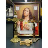 Two vintage brass crucifixes, one inset with amber, together with a framed print and enamelled