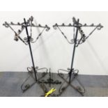 A pair of wrought iron ecclesiastical candel holders and two similar wall mounted candle holders, H.