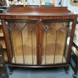 A 19th C bow fronted mahogany cabinet with ball and claw feet, one glass shelf, 130 x 120 x 32cm.