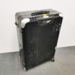 A Rimowa hard suitcase with metal corners and wheels, 72 x 50 x 26cm.