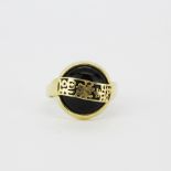 A 14ct yellow gold and onyx ring with Chinese characters, (K).