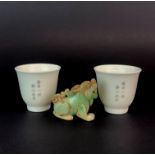A pair of fine Chinese porcelain wine cups, H. 4.5cm. together with a Chinese carved jade figure