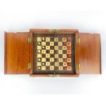 A mahogany cased Edwardian travelling chess set with turned bone pieces, case size 20 x 20cm. ( Four
