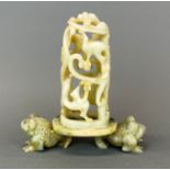 An unusual Chinese carved soapstone censer of a basket of dragons supported on two figures of