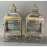 A pair of bronzed finish metal and glass storm lanterns, H. 56cm.