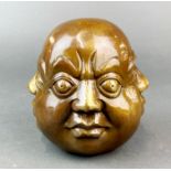 A Chinese bronze four headed paperweight, H. 12cm. Dia. 11cm.