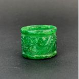 A Chinese carved jade archers ring decorated with a dragon, W. 2.5cm. Dia. 3.2cm.