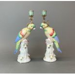A pair of Continental ormolu mounted porcelain parrot candlesticks, H. 36cm.