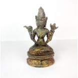 A Tibetan bronze figure of a seated three headed deity, H. 16cm.