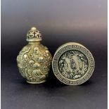 A Chinese white metal snuff bottle decorated in relief with Lohan, H. 7.5cm. Together with a Chinese