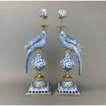 A pair of ormolu mounted porcelain parrot candlesticks, H, 49cm.