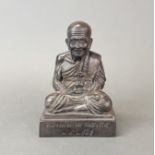 A Siamese bronze figure of a seated Buddhist monk, H. 20cm.