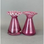 A pair of frilled cranberry glass vases, H. 17cm.