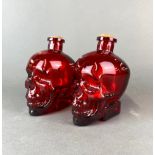 A pair of glass skull bottles, H. 17cm.