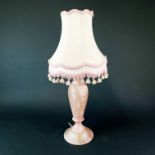 A pink polished marble table lamp and shade, H. 57cm.