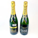 Two vintage bottles of Moet and Chandon champagne 2000 and 2002.