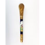 A 19th Century porcelain and gilt metal cane handle, L. 20cm.