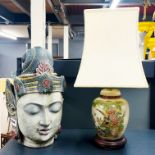 A painted composition Buddha head, H. 32cm. Together with an Oriental design table lamp.