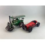 Two tin models, one of a steam roller and the other a 1930's racing car, steam roller size 32 x